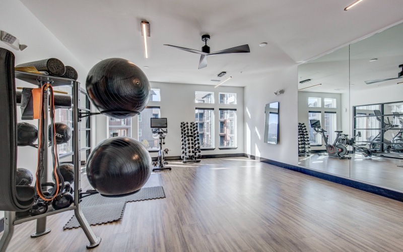 fitness center with open spot for yoga