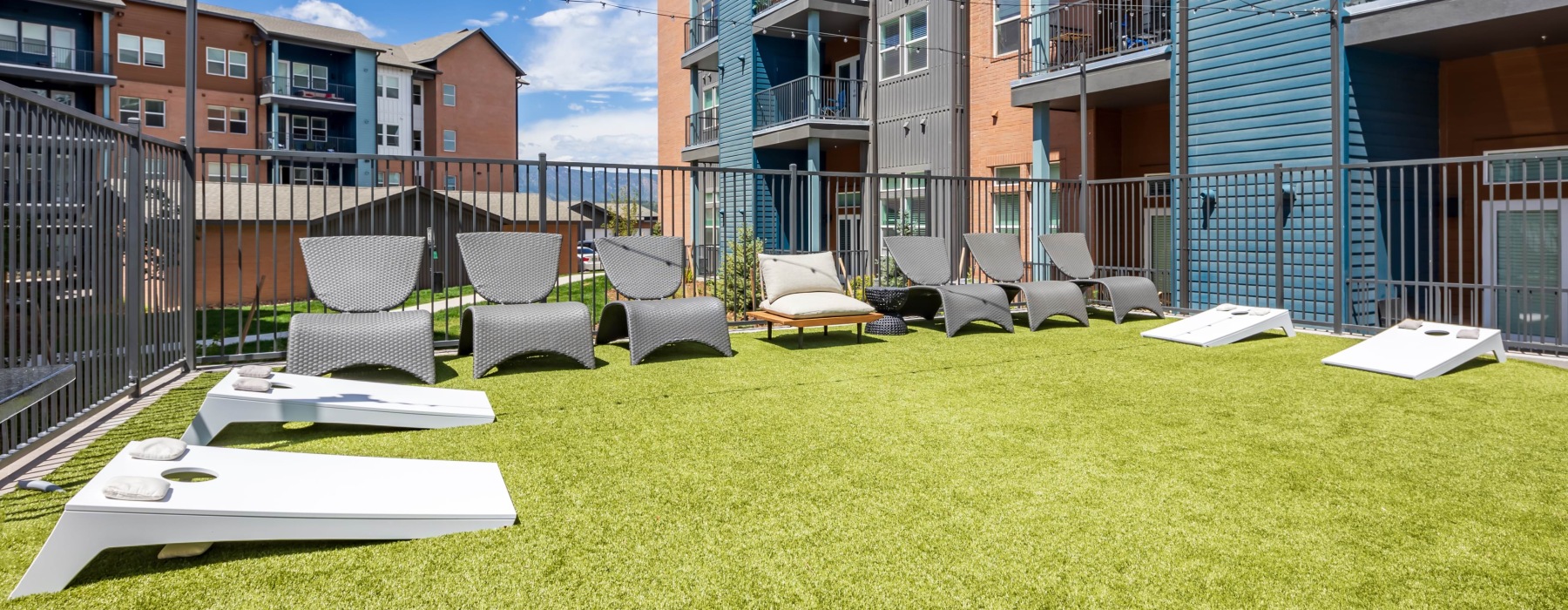 Outdoor game area with seating and hanging lights
